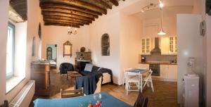 a living room and kitchen with a couch and a table at Petra Traditional House in Episkopión