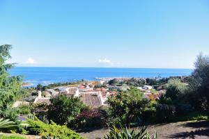 a view of a resort with the ocean in the background at FIUMICELLI in Sari Solenzara