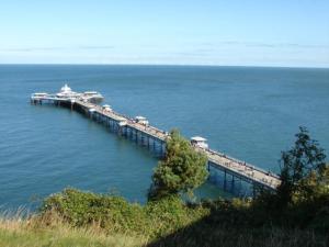 a pier in the middle of a large body of water at VICTORIA 24 in Llandudno