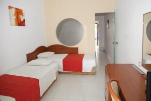 Ein Bett oder Betten in einem Zimmer der Unterkunft Rodos Star Hotel