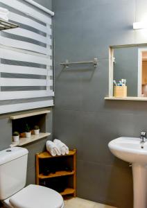 a bathroom with a white toilet and a sink at DARSISS 1 - Museum Apartment in Athens