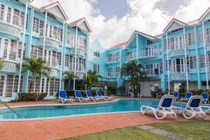 a resort with a swimming pool and lounge chairs at Bay Gardens Marina Haven in Gros Islet