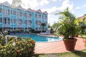 a resort with a swimming pool and a building at Bay Gardens Marina Haven in Gros Islet