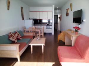 a living room with a couch and a table at Azahara Beach 416 in Los Cristianos