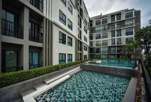 a swimming pool in the middle of a building at Zcape at Bangtao in Bang Tao Beach