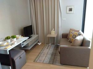a small living room with a couch and a table at Zcape at Bangtao in Bang Tao Beach