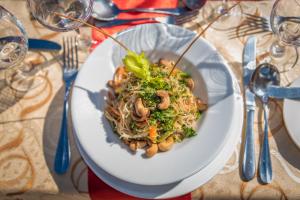 a white plate of food on a table at Bay Gardens Marina Haven in Gros Islet