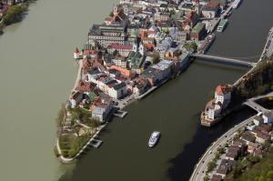 
boats are docked in the water near a city at Altstadt-Hotel Passau in Passau
