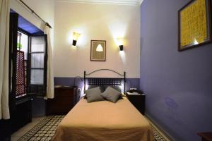 Ein Bett oder Betten in einem Zimmer der Unterkunft Hotel Casa de los Azulejos