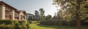 a courtyard of a building with bushes and trees at Parc Arradoy in Saint-Jean-Pied-de-Port