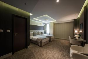 Katil atau katil-katil dalam bilik di Garni Hotel Aveny