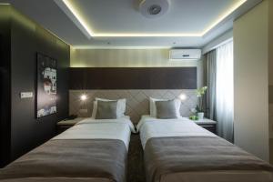 Katil atau katil-katil dalam bilik di Garni Hotel Aveny