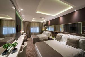 Katil atau katil-katil dalam bilik di Garni Hotel Aveny