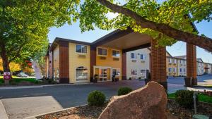a building with a tree in front of it at Best Western Plus Meridian in Meridian