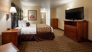 a hotel room with a bed and a flat screen tv at Best Western Plus Meridian in Meridian +23 photos