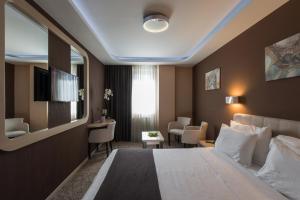 Katil atau katil-katil dalam bilik di Garni Hotel Aveny