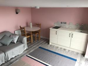 a living room with a couch and a table at Fistral Hideaway in Newquay