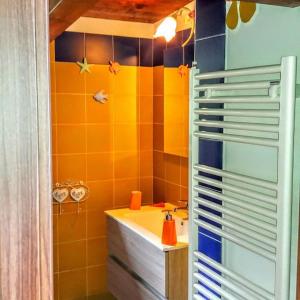 a bathroom with orange and blue tiles and a sink at B&B Le Anthos in Marina di Camerota