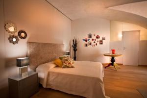 a bedroom with a bed and a table in a room at Anfite Luxury Apartment Volto San Luca in Verona