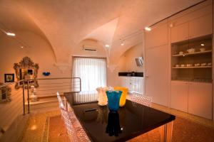 a kitchen with a table with a vase on it at Anfite Luxury Apartment Volto San Luca in Verona +31 photos