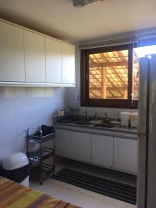 a kitchen with a sink and a window at Condomínio Reserva Imbassai in Imbassai