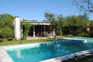 a swimming pool in front of a house at Casas del Champaquí in San Javier