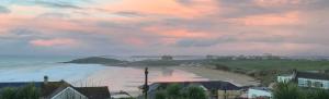 a view of a beach at sunset with a cloudy sky at Fistral Hideaway in Newquay