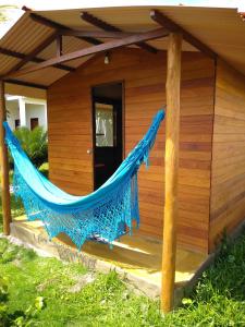 a hammock on the porch of a house at Family Guest House in Ilha de Boipeba