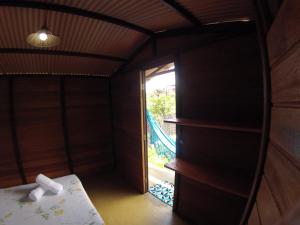 a room with a bed and a sliding glass door at Family Guest House in Ilha de Boipeba