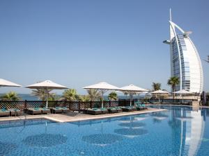 a large swimming pool with a balcony overlooking the ocean at Jumeirah Mina A'Salam in Dubai