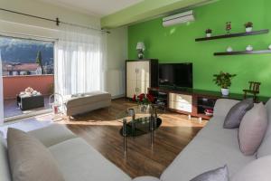 a living room with a couch and a tv at Green Paradise Estate Trilj in Trilj