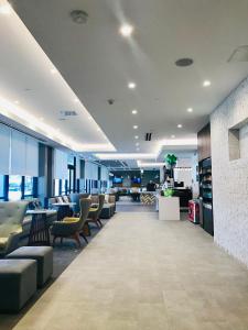 a lobby with couches and chairs in a building at Wyndham Garden Ft Lauderdale Airport & Cruise Port in Dania Beach
