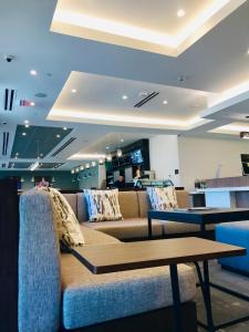 a living room with a couch and a table at Wyndham Garden Ft Lauderdale Airport & Cruise Port in Dania Beach