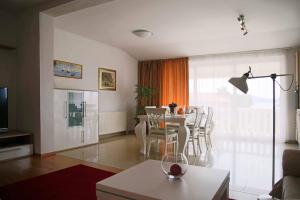 a living room with a table and a dining room at Villa Spanja in Vodice