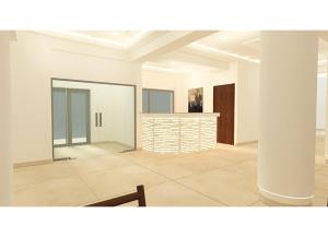 a white room with a pillar and a table at Livas Hotel Apartments in Protaras +43 photos