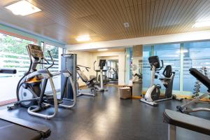 a gym with several treadmills and cardio machines at signinahotel in Laax