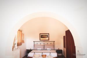 Un ou plusieurs lits dans un hébergement de l'établissement Villa Palmirotta Trulli Relais
