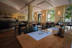 un comedor con mesas y sillas en un restaurante en Guest House Dieci allo Zoo, en Zúrich