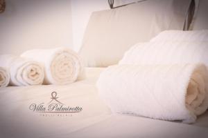 Ένα ή περισσότερα κρεβάτια σε δωμάτιο στο Villa Palmirotta Trulli Relais