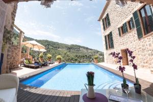 a villa with a swimming pool and a patio at Villa Can Sarales - Deia in Deia