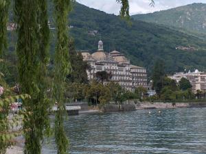 a large building sitting on the side of a river at Grand Hotel des Iles Borromées & SPA in Stresa