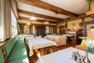 a dining room with tables and a pool table at Pension Stoffenbauer in Ramsau am Dachstein