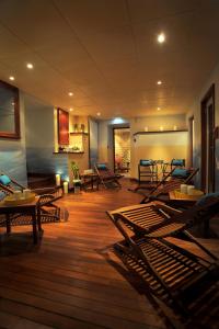 a room with wooden floors and chairs and tables at Hôtel L'Yeuse - Teritoria in Châteaubernard +65 photos