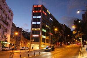 a tall building on a city street at night at easyHotel Lisbon in Lisbon