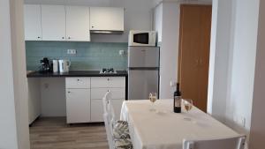 a kitchen with a table and two glasses of wine at Cluj Accommodation Nasaud in Cluj-Napoca