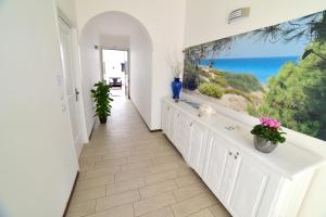a white hallway with a view of the ocean at Case Vacanza Via Mozart in Porto Cesareo