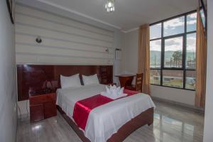 Postelja oz. postelje v sobi nastanitve Hotel Suite Naylamp Zyon