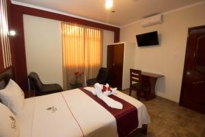 Postelja oz. postelje v sobi nastanitve Hotel Suite Naylamp Zyon