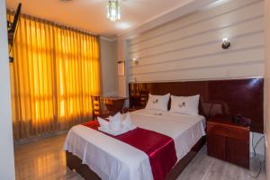 Postelja oz. postelje v sobi nastanitve Hotel Suite Naylamp Zyon