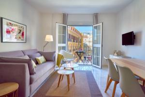 a living room with a couch and a table at iloftmalaga Puerta del Mar in Málaga